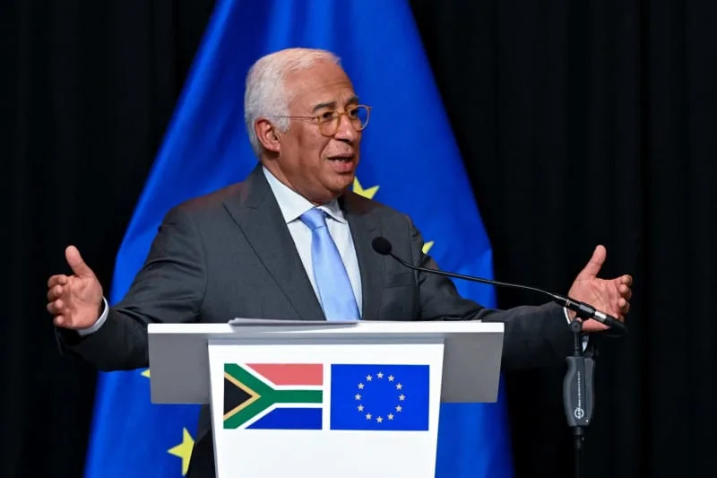 A G20 podium with EU flag and South African flag as a speaker addresses the Ukraine plan